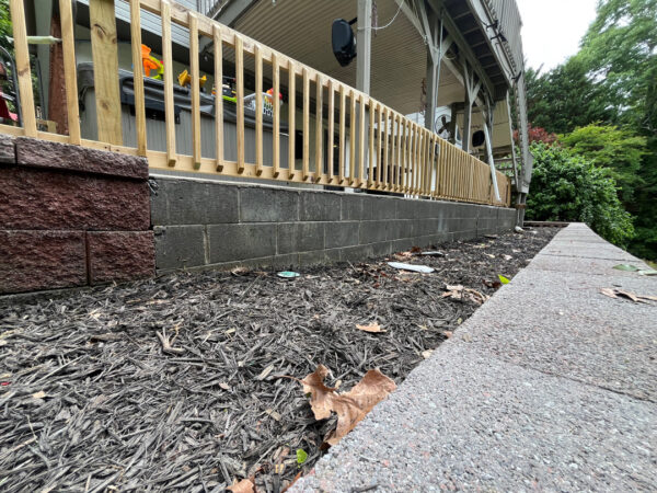 This comprehensive exterior cleaning project involved a full soft wash of the home's surfaces, a dedicated pressure wash of concrete hardscapes and retaining walls, and a gentle cleaning of the wood deck and mailbox to remove organic growth and restore the property's appearance.
