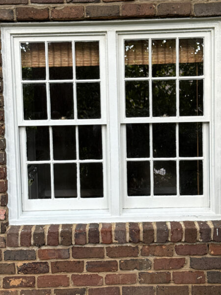 This project involved a comprehensive soft wash and detailed exterior cleaning of a Chattanooga residence, encompassing the house, porches, concrete surfaces, gutters, and outbuildings to remove organic buildup and restore a uniform appearance.