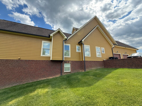 This comprehensive exterior restoration in Soddy-Daisy utilized professional soft-wash and pressure washing techniques to clean the home's siding, concrete surfaces, pool deck, three wood decks, patio furniture, retaining walls, and both interior and exterior windows.