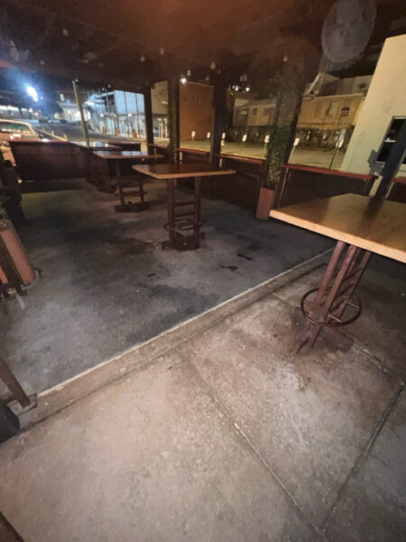 This project involved pressure washing a Chattanooga restaurant's front sidewalk, customer patio, and dumpster area using a municipal fire hydrant water source to remove dirt, stains, and grease for a cleaner appearance.