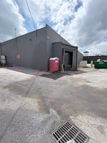 This project involved targeted oil stain remediation on an asphalt parking lot using heated water and specialized chemicals, combined with a comprehensive low-pressure soft wash of the commercial building's masonry exterior to remove organic growth and contaminants.