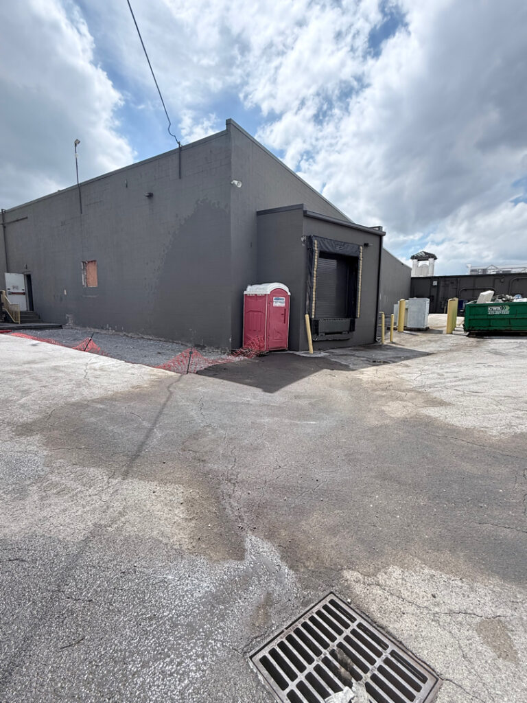 This project involved targeted oil stain remediation on an asphalt parking lot using heated water and specialized chemicals, combined with a comprehensive low-pressure soft wash of the commercial building's masonry exterior to remove organic growth and contaminants.