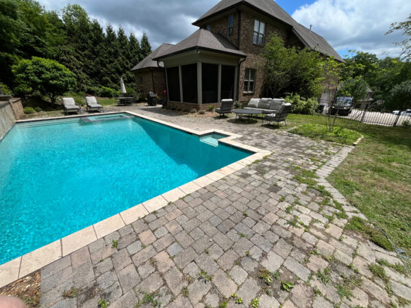 This project involved restoring a patio's appearance through a thorough, chemical-free pressure washing process that removed weeds, organic growth, and debris to refresh the natural color of the hardscape.