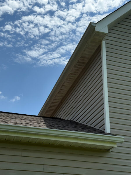 This project involved a comprehensive soft wash and gentle scrubbing of a two-story home's exterior, front steps, retaining wall, and covered back porch in Apison to remove organic buildup and grime, backed by a 1-year mold and mildew warranty.