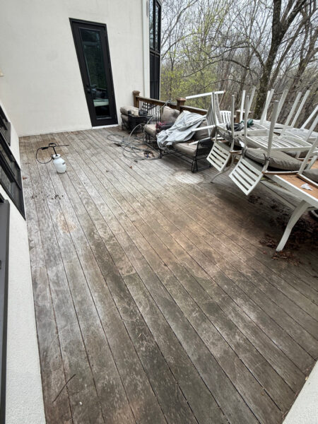 The work performed consists of soft washing and rinsing the primary structure's exterior surfaces, three rear decks, a treehouse with its decks and bridges, and surface cleaning the concrete flatwork, all backed by a one-year warranty against mold and mildew regrowth.