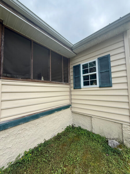 This project involved a comprehensive low-pressure soft wash of a single-story home's exterior surfaces, including siding, trim, and gutters, to remove organic growth and restore a uniform appearance.