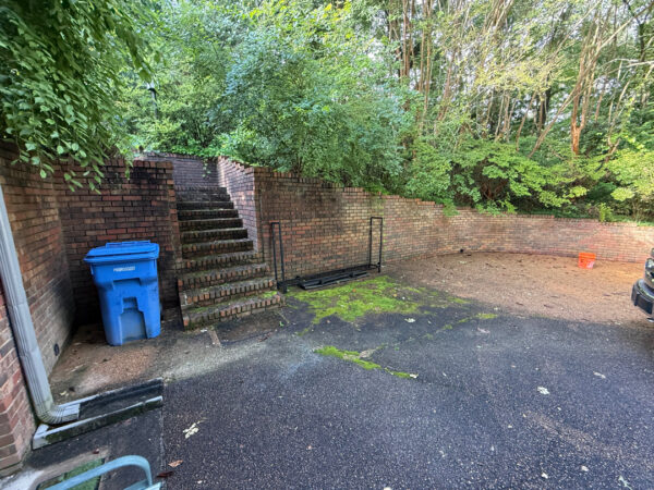 This project involved a comprehensive exterior cleaning of a Chattanooga residence's retaining wall, patio pavers, driveway, and front porch using specialized detergents and pressure washing to remove organic growth and surface debris.