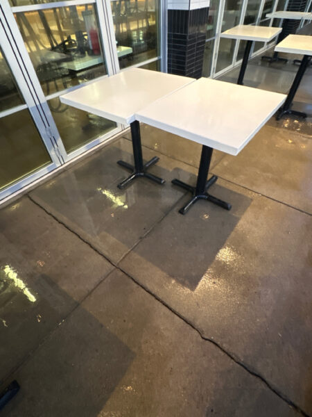 The front patio concrete at Milk and Honey was professionally restored through a multi-step process involving site protection, specialized detergent application, targeted pressure washing, and a final rinse to remove organic growth and grease.