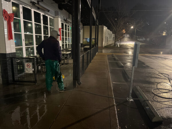The front patio concrete at Milk and Honey was professionally restored through a multi-step process involving site protection, specialized detergent application, targeted pressure washing, and a final rinse to remove organic growth and grease.