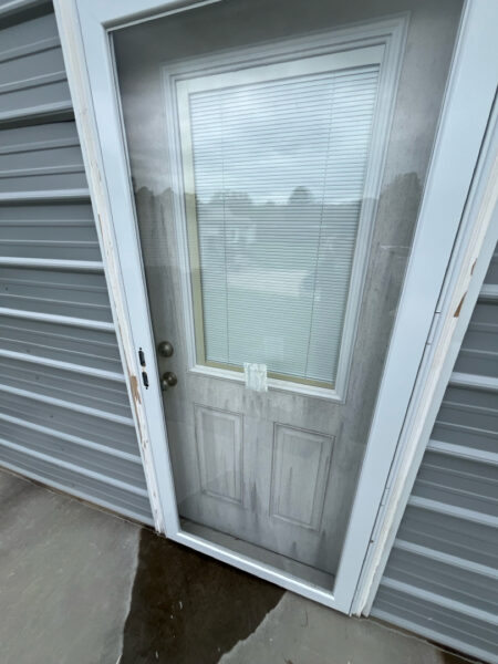 Professional soft wash exterior cleaning will be performed on the main house, porches, and three garage buildings, targeting all vertical surfaces and roofline components to remove organic growth and debris with a one-year warranty.
