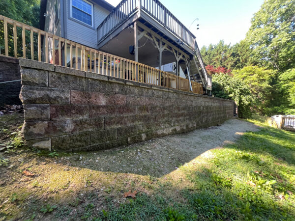 This comprehensive exterior cleaning project involved a full soft wash of the home's surfaces, a dedicated pressure wash of concrete hardscapes and retaining walls, and a gentle cleaning of the wood deck and mailbox to remove organic growth and restore the property's appearance.