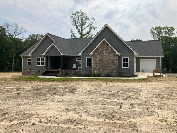 This project involved a comprehensive exterior soft wash of a one-story residence in Rising Fawn to remove organic buildup and meet a one-year mold warranty, alongside a detailed concrete cleaning of the front walkway and garage pad using pre-treatment and a surface washer.