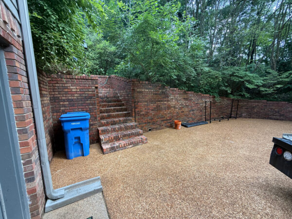 This project involved a comprehensive exterior cleaning of a Chattanooga residence's retaining wall, patio pavers, driveway, and front porch using specialized detergents and pressure washing to remove organic growth and surface debris.