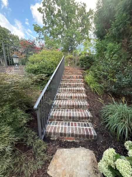 This project involved a comprehensive soft wash and detailed exterior cleaning of a Chattanooga residence, encompassing the house, porches, concrete surfaces, gutters, and outbuildings to remove organic buildup and restore a uniform appearance.