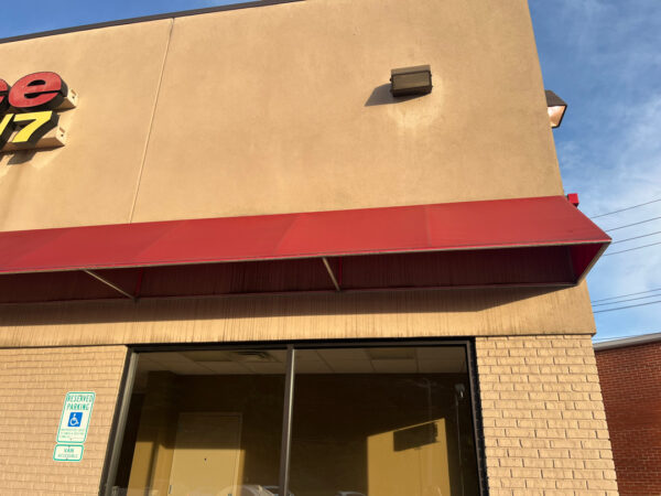 The team performed a specialized low-pressure soft wash on a commercial awning system and a professional power wash on adjacent concrete surfaces in Chattanooga to remove organic growth and restore the property's curb appeal.