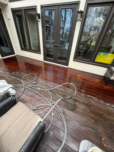 The work performed consists of soft washing and rinsing the primary structure's exterior surfaces, three rear decks, a treehouse with its decks and bridges, and surface cleaning the concrete flatwork, all backed by a one-year warranty against mold and mildew regrowth.