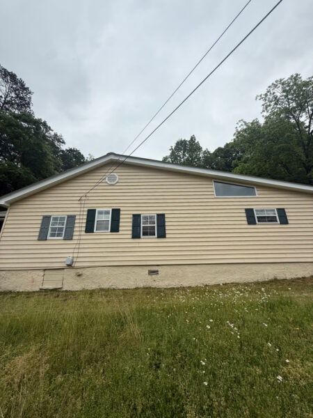 This project involved a comprehensive low-pressure soft wash of a single-story home's exterior surfaces, including siding, trim, and gutters, to remove organic growth and restore a uniform appearance.