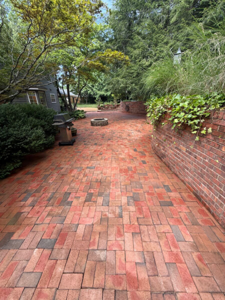 This project involved a comprehensive exterior cleaning of a Chattanooga residence's retaining wall, patio pavers, driveway, and front porch using specialized detergents and pressure washing to remove organic growth and surface debris.