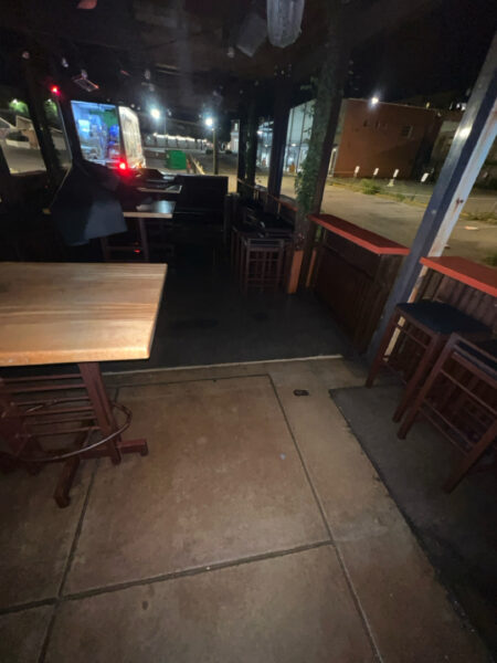 This project involved pressure washing a Chattanooga restaurant's front sidewalk, customer patio, and dumpster area using a municipal fire hydrant water source to remove dirt, stains, and grease for a cleaner appearance.