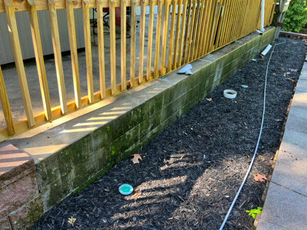 This comprehensive exterior cleaning project involved a full soft wash of the home's surfaces, a dedicated pressure wash of concrete hardscapes and retaining walls, and a gentle cleaning of the wood deck and mailbox to remove organic growth and restore the property's appearance.