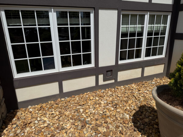 This Chattanooga project utilized surface and soft washing techniques to deep clean the rear walkway, under-deck concrete, and 1896 bar patio while specifically removing red clay stains from the chimney and retaining walls.