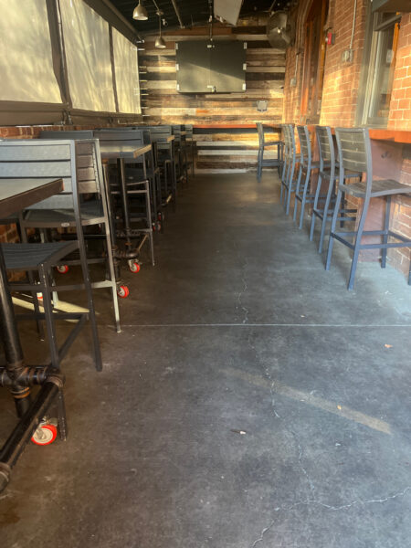 The project at Urban Stack in Chattanooga involved inspecting and thoroughly pressure washing the restaurant's exterior sidewalks, dining patios, and side entrance to remove dirt, stains, and grease, thereby restoring a clean appearance and improving pedestrian safety.