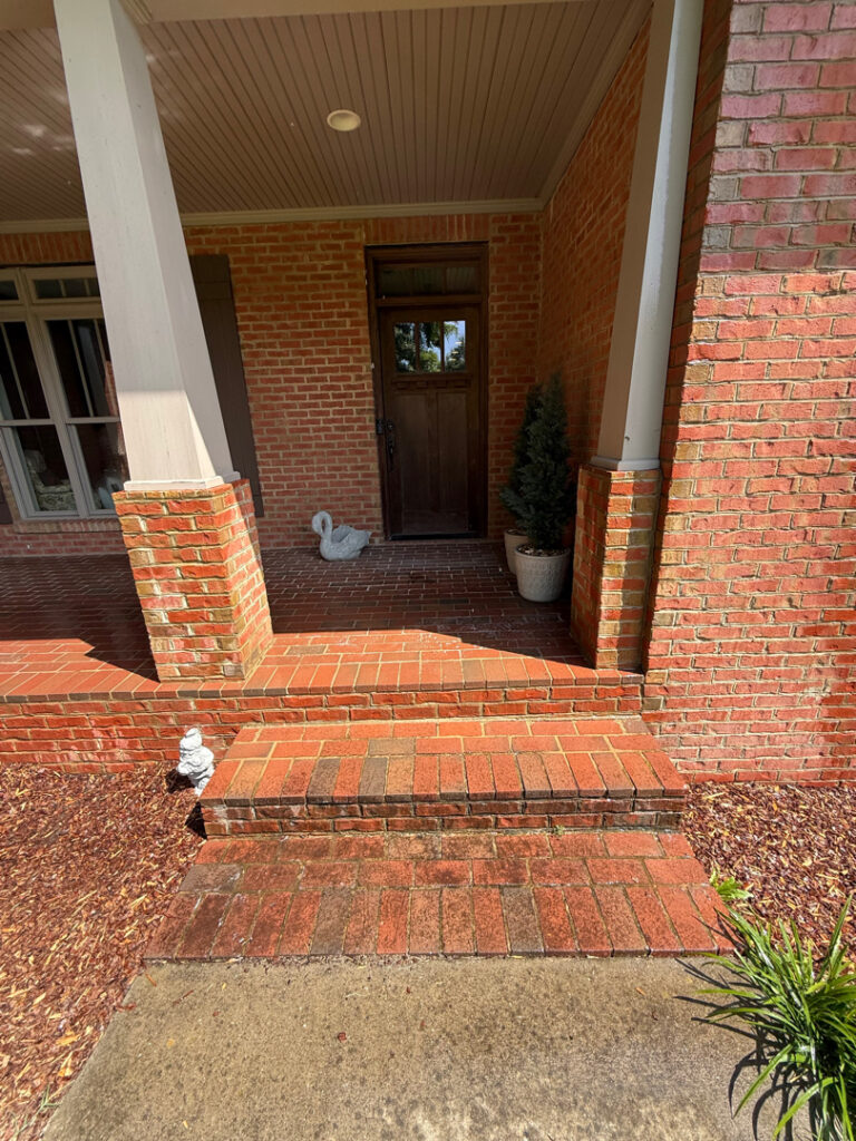 This project involved a complete, low-pressure soft wash and targeted manual agitation of all paintable exterior surfaces, excluding the brickwork, of a two-story residence in Chickamauga to remove organic growth and environmental buildup.