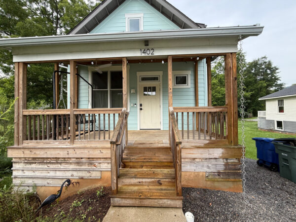 Using low-pressure soft washing methods, this project completed a full exterior refresh of a two-story home in Chattanooga, which included cleaning the house siding, front porch and back steps, washing the metal roof, and clearing and flushing the gutter system.