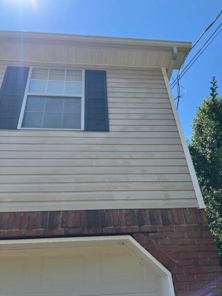 This project involved a comprehensive soft wash of the home's exterior and screened porch, complemented by surface cleaning of the concrete driveway, walkways, and a retaining wall to remove organic growth and debris.