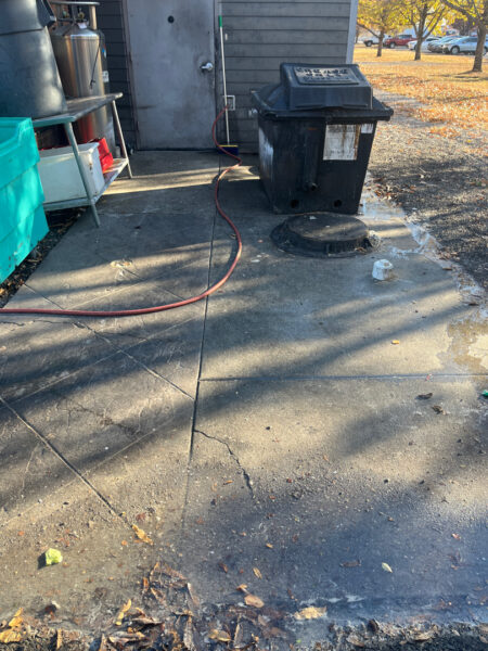 The project at Urban Stack in Chattanooga involved inspecting and thoroughly pressure washing the restaurant's exterior sidewalks, dining patios, and side entrance to remove dirt, stains, and grease, thereby restoring a clean appearance and improving pedestrian safety.