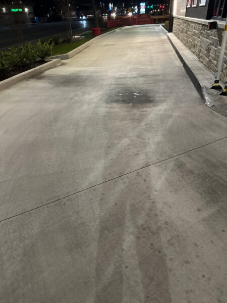 This commercial exterior restoration project in Ooltewah revitalized the property's curb appeal by thoroughly cleaning the building's facade, awnings, drive-thru lane, dumpster pad, and parking areas to remove heavy grime, stains, and organic buildup.