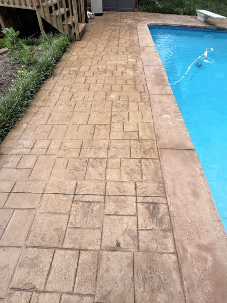 Professional cleaning and pressure washing were performed on a concrete pool deck and a retaining wall in Chattanooga to remove mold, mildew, and grime through the application of specialized detergents and methodical surface washing.