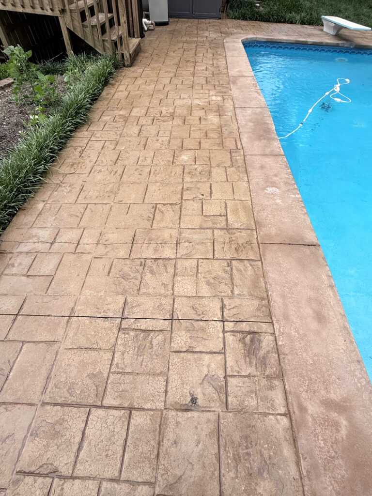 Professional cleaning and pressure washing were performed on a concrete pool deck and a retaining wall in Chattanooga to remove mold, mildew, and grime through the application of specialized detergents and methodical surface washing.