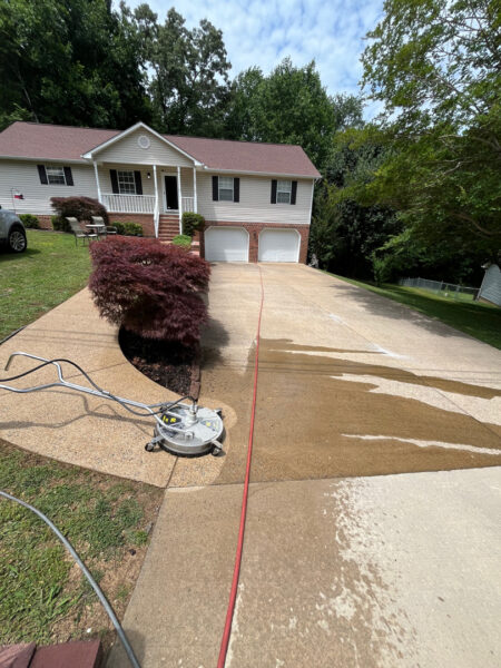 This project involved a comprehensive soft wash of the home's exterior and screened porch, complemented by surface cleaning of the concrete driveway, walkways, and a retaining wall to remove organic growth and debris.