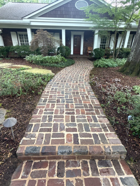 This project involved a comprehensive soft wash and detailed exterior cleaning of a Chattanooga residence, encompassing the house, porches, concrete surfaces, gutters, and outbuildings to remove organic buildup and restore a uniform appearance.