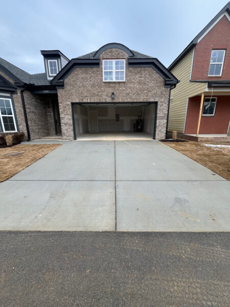 The project involved a comprehensive exterior rinse of a newly constructed home in Chattanooga, including the siding, garage, driveway, and walkways, to remove construction dust and debris for a move-in-ready finish.