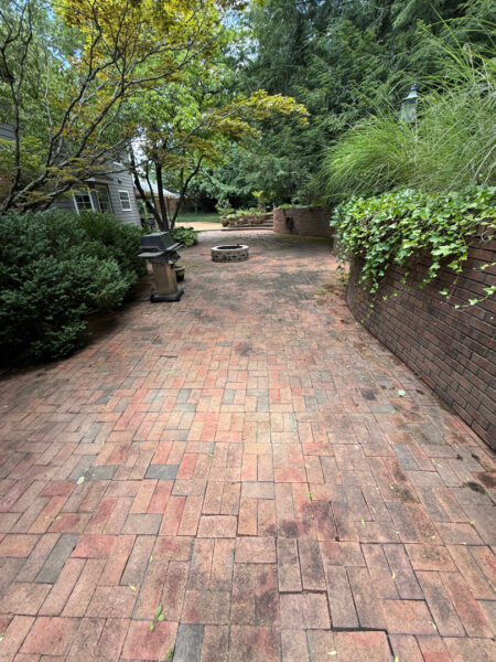 This project involved a comprehensive exterior cleaning of a Chattanooga residence's retaining wall, patio pavers, driveway, and front porch using specialized detergents and pressure washing to remove organic growth and surface debris.