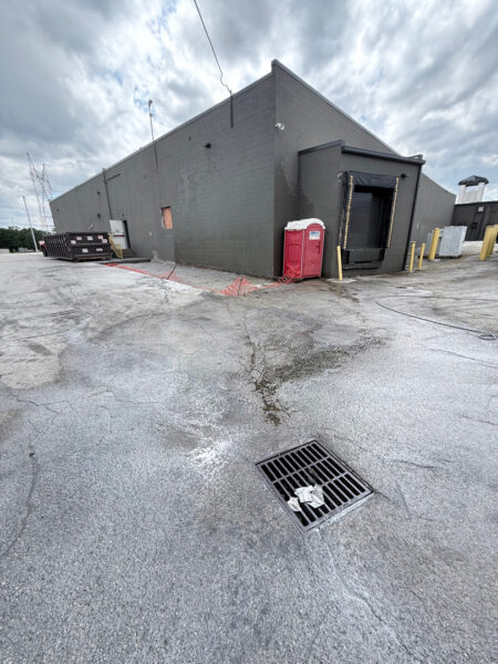 This project involved targeted oil stain remediation on an asphalt parking lot using heated water and specialized chemicals, combined with a comprehensive low-pressure soft wash of the commercial building's masonry exterior to remove organic growth and contaminants.