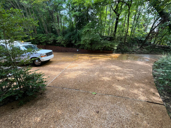 This project involved a comprehensive exterior cleaning of a Chattanooga residence's retaining wall, patio pavers, driveway, and front porch using specialized detergents and pressure washing to remove organic growth and surface debris.