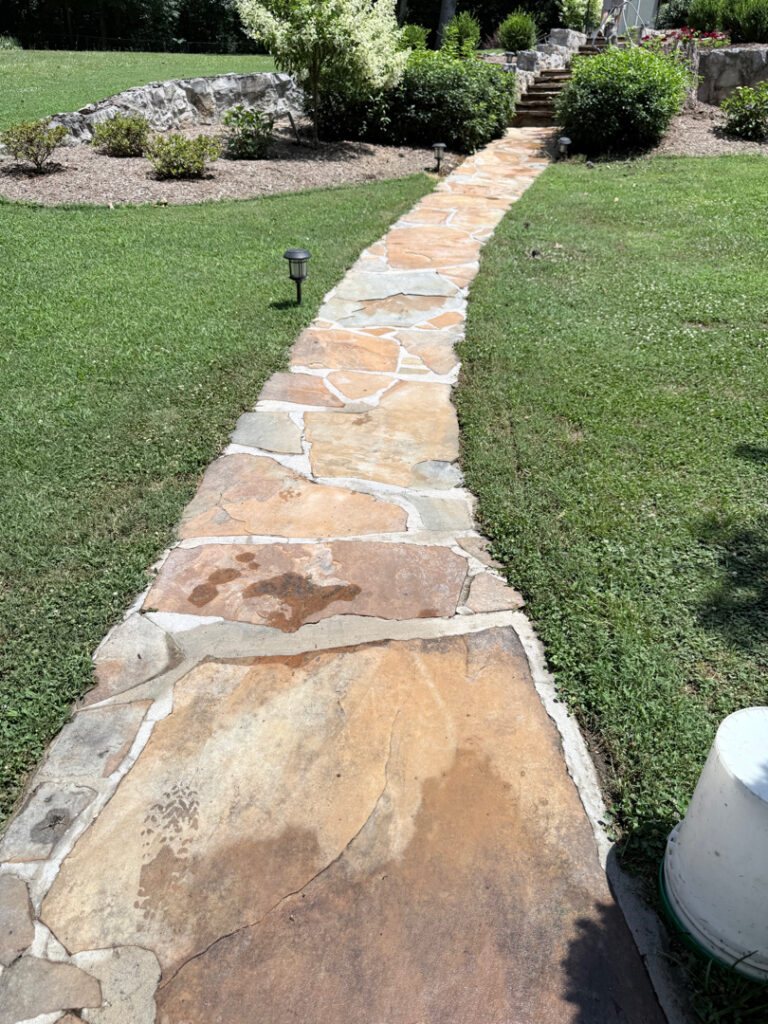 The contractor performed a comprehensive exterior cleaning in Chickamauga, utilizing soft washing for the home and workshop siding and professional surface cleaning for all concrete driveways, walkways, and patios.