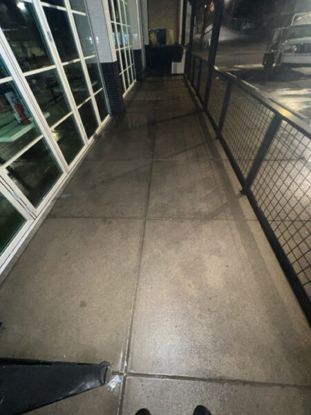 The front patio concrete at Milk and Honey was professionally restored through a multi-step process involving site protection, specialized detergent application, targeted pressure washing, and a final rinse to remove organic growth and grease.