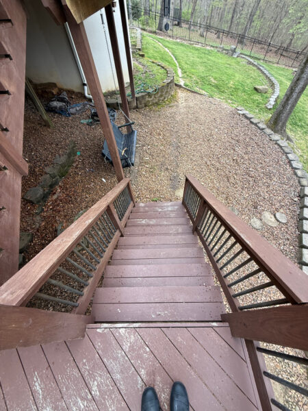 The work performed consists of soft washing and rinsing the primary structure's exterior surfaces, three rear decks, a treehouse with its decks and bridges, and surface cleaning the concrete flatwork, all backed by a one-year warranty against mold and mildew regrowth.