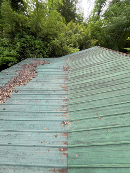 This project involved the soft washing of a one-story residence's exterior, its driveway and walkway pavers, and a stone fountain, alongside the cleaning of a commercial metal roof, to remove organic growth and restore the appearance of all surfaces in McDonald.