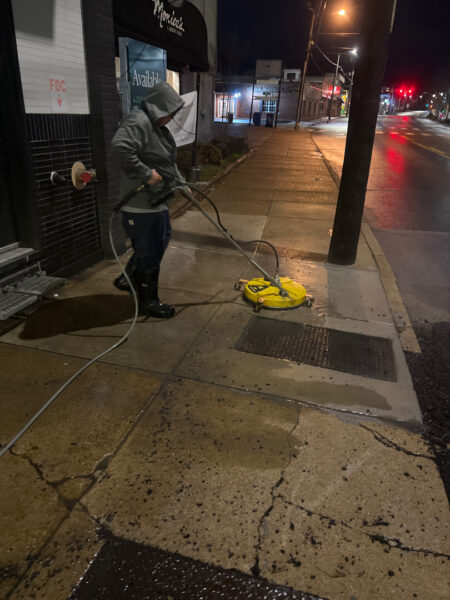 The front patio concrete at Milk and Honey was professionally restored through a multi-step process involving site protection, specialized detergent application, targeted pressure washing, and a final rinse to remove organic growth and grease.