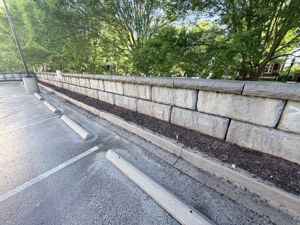 This project in Chattanooga utilized specialized soft wash and surface cleaning techniques to remove organic growth and contaminants from a retaining wall and street light concrete bases while preserving the structural integrity of the masonry.