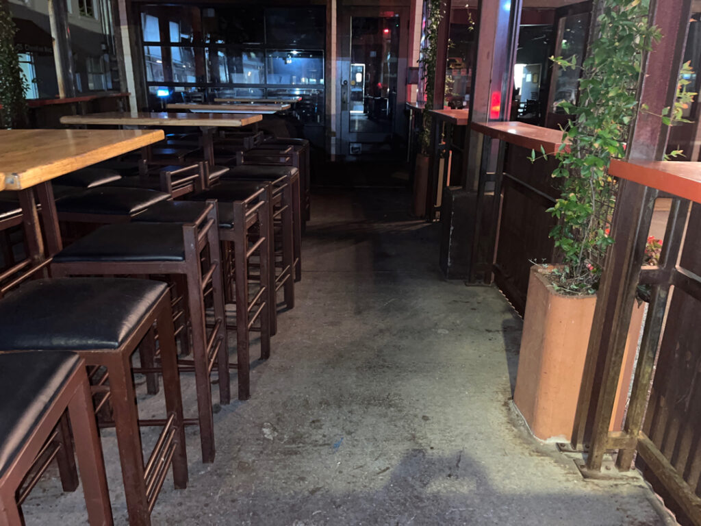 This project involved pressure washing a Chattanooga restaurant's front sidewalk, customer patio, and dumpster area using a municipal fire hydrant water source to remove dirt, stains, and grease for a cleaner appearance.