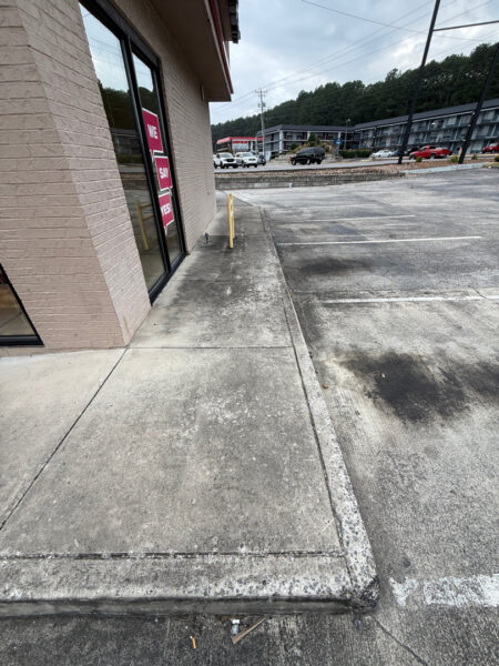 This commercial cleaning project in Cleveland utilized low-pressure soft washing to remove organic growth from the building's masonry and surface washing to refresh the surrounding concrete sidewalks.