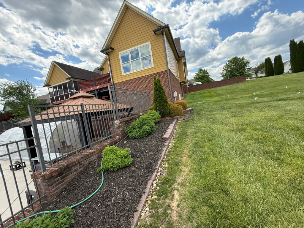 This comprehensive exterior restoration in Soddy-Daisy utilized professional soft-wash and pressure washing techniques to clean the home's siding, concrete surfaces, pool deck, three wood decks, patio furniture, retaining walls, and both interior and exterior windows.