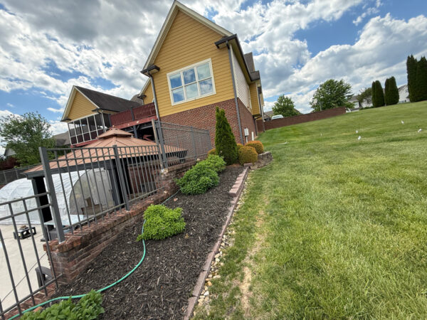 This comprehensive exterior restoration in Soddy-Daisy utilized professional soft-wash and pressure washing techniques to clean the home's siding, concrete surfaces, pool deck, three wood decks, patio furniture, retaining walls, and both interior and exterior windows.