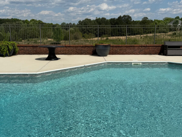 This comprehensive exterior restoration in Soddy-Daisy utilized professional soft-wash and pressure washing techniques to clean the home's siding, concrete surfaces, pool deck, three wood decks, patio furniture, retaining walls, and both interior and exterior windows.